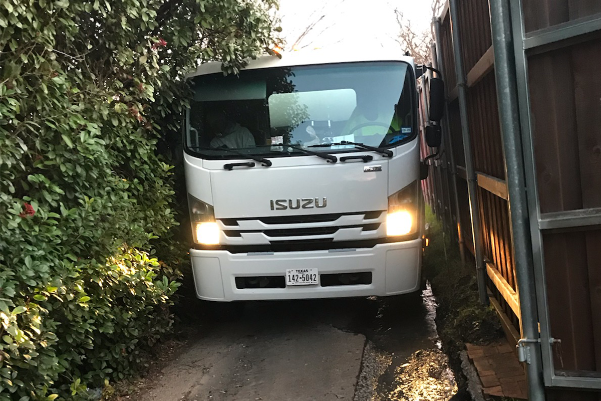 Trucks squeeze between obstructions and encroachments.