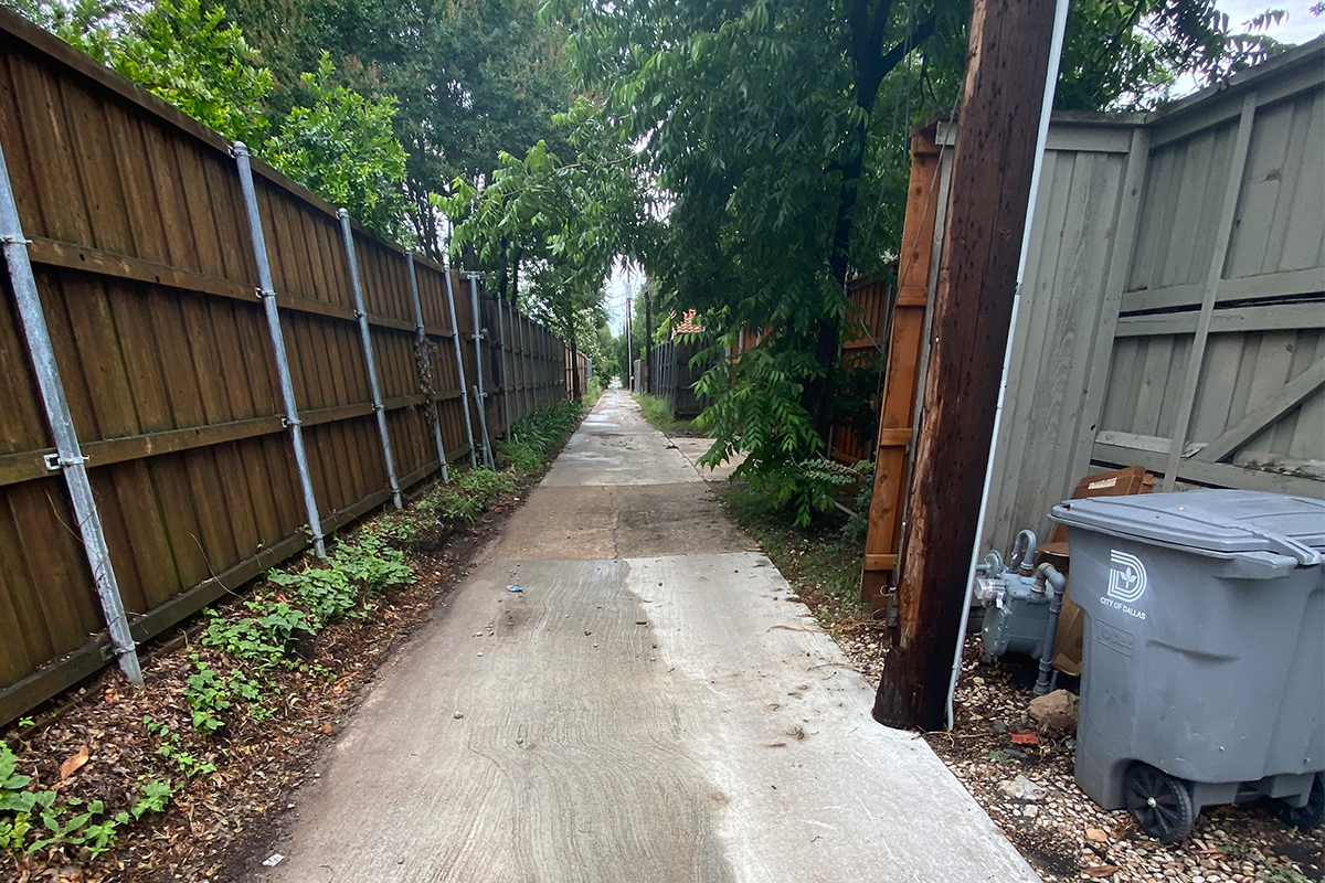 Narrow alley with utility obstruction and limited easement.