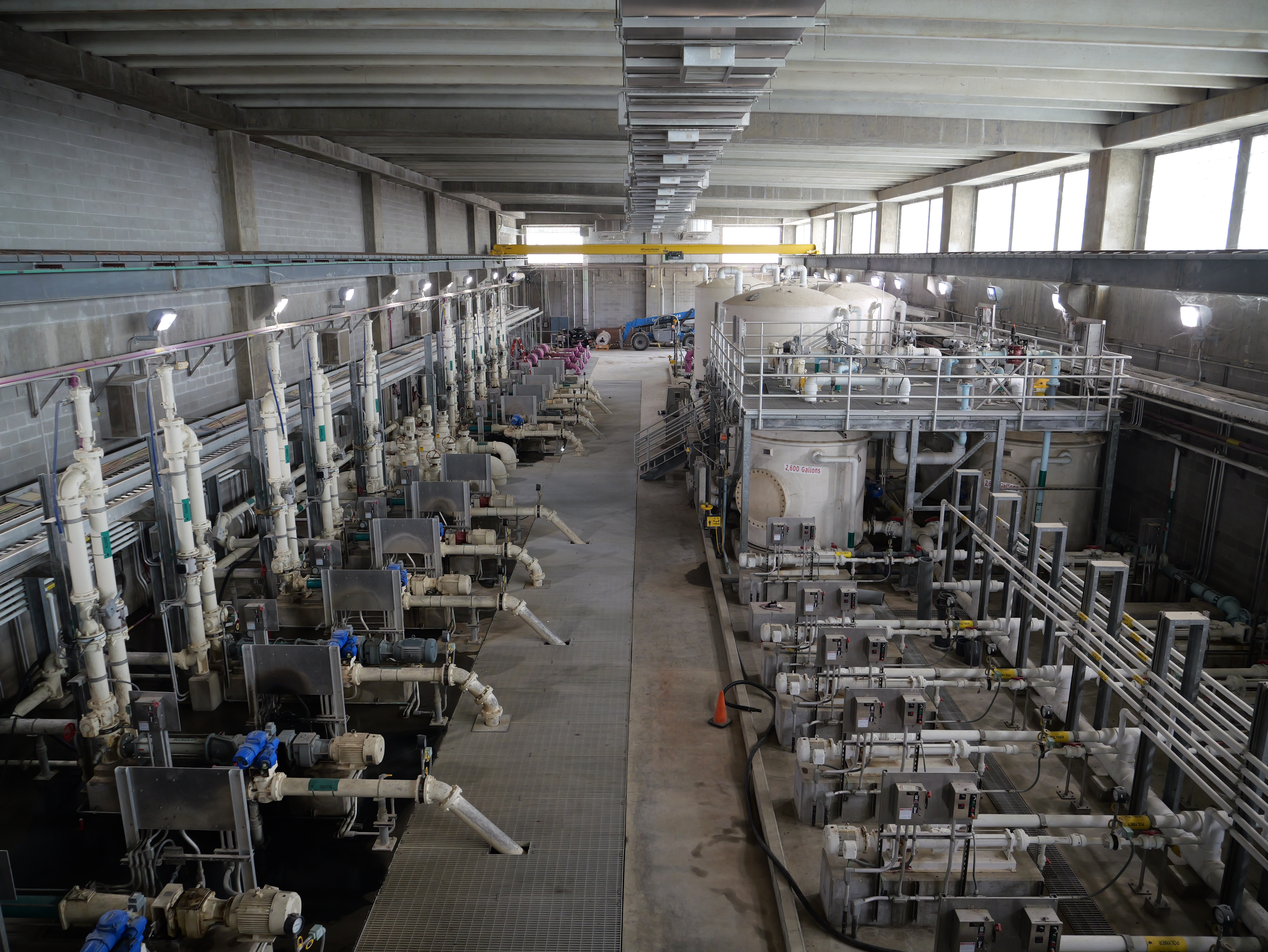 Piping system inside building along side large storage tanks
